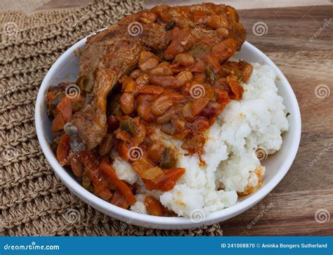 South African Pap and Chicken on Rustic African Table Stock Photo ...