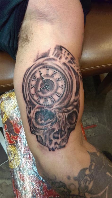 Great-skull-clock-arm-tattoo.jpg