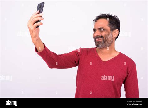 Portrait Of Happy Mature Handsome Bearded Indian Man Taking Selfie