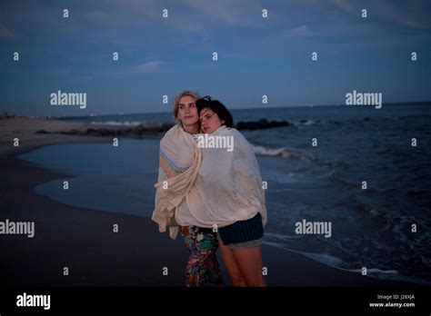 Friends hanging out on a beach Stock Photo - Alamy