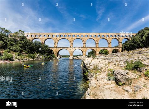 Kayaking Under The Three Tiered Roman Aqueduct Over The River Gardon