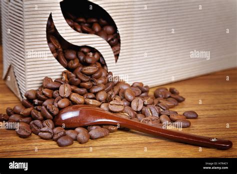 Coffee Beans Spill Out Of The Box On The Table Stock Photo Alamy