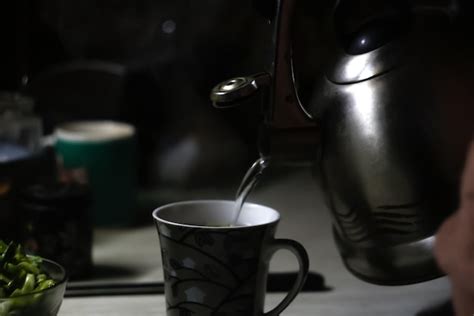 Premium Photo Kettle Pouring Into Mug Kettle Pouring Boiling Water