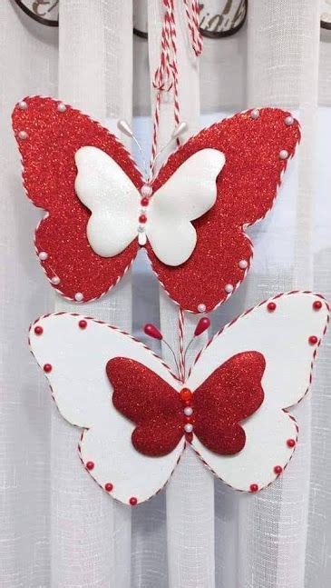 Two Red And White Butterflies Hanging From A Curtain