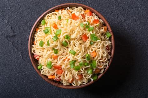 Premium Photo Instant Noodles In Bowl With Carrot Tomatoes And Onion