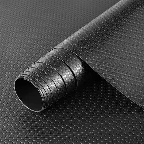 A Close Up View Of A Black Textured Surface With An Oval Design On It