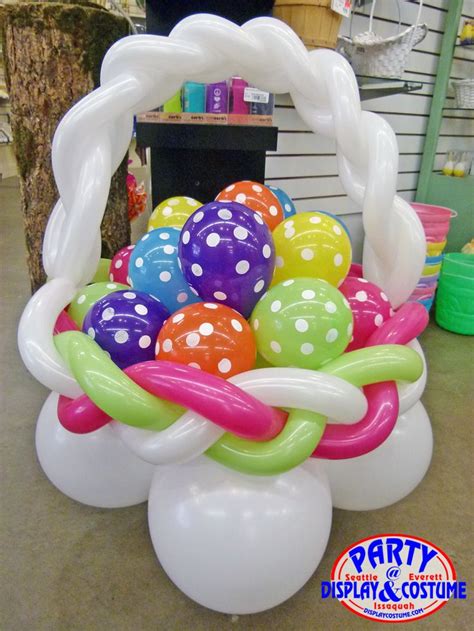 A Basket Filled With Balloons Sitting On Top Of A Table