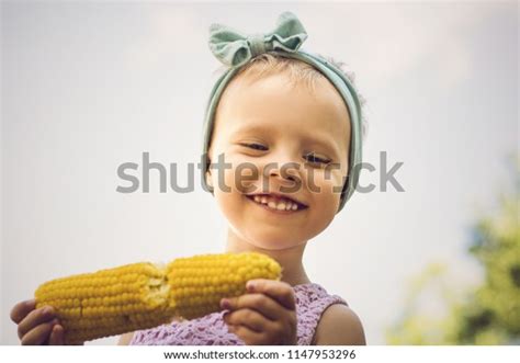 Little Girl Eating Corn Outdoors Healthy Stock Photo 1147953296