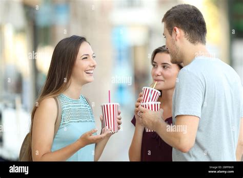 Three Happy Friends Talking And Drinking Takeaway Refreshments Standing