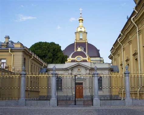 A Large Building With A Golden Dome On Top And A Gate In The Foreground