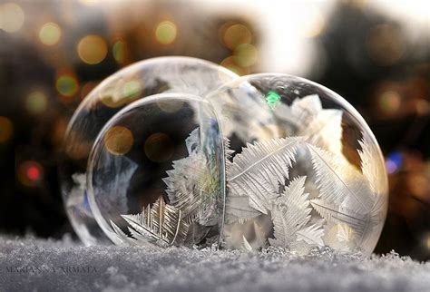 Two Snow Globes Sitting On Top Of A Pile Of Snow