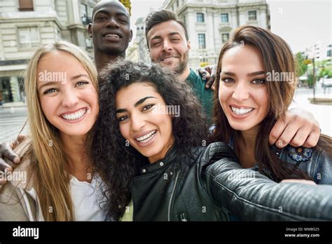 Multiracial Group Of Friends Taking Selfie In A Urban Street With A