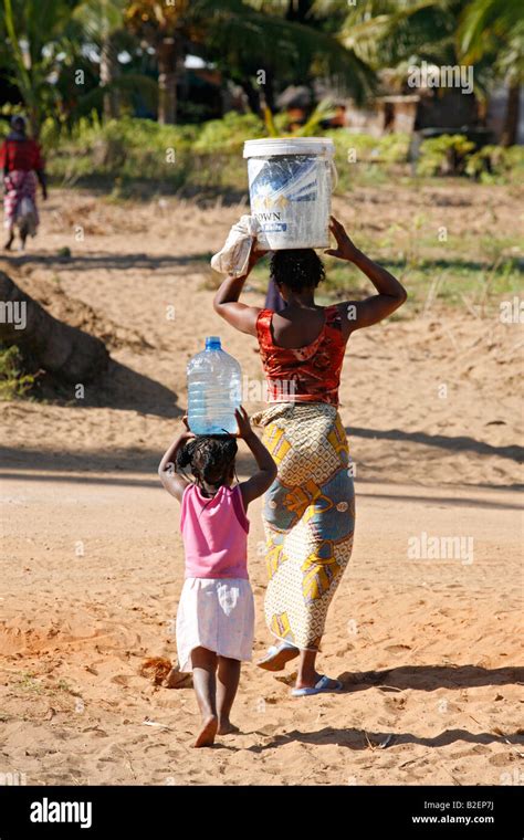 African Woman Carrying Water On Head High Resolution Stock Photography