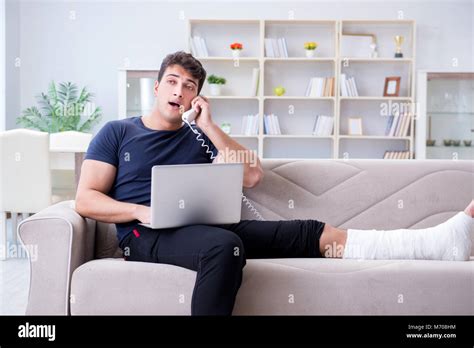 Man With Broken Leg Recovering At Home Stock Photo Alamy