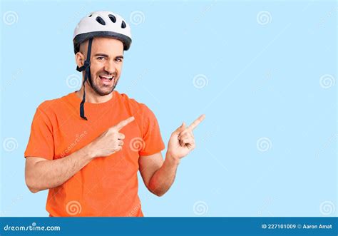 Young Handsome Man Wearing Bike Helmet Smiling And Looking At The