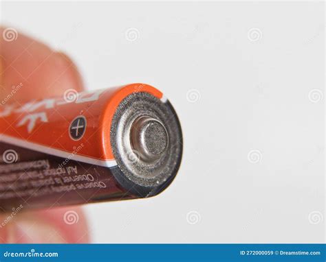 Hand Holding AA Batterie Isolated On White Background Stock Image