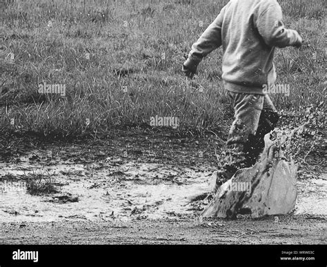 Boy Puddle Splashing Black And White Stock Photos And Images Alamy