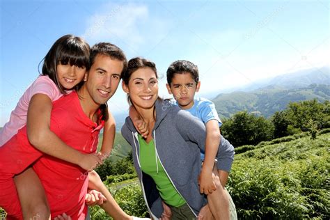 parents  children standing  natural landscape stock photo