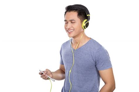 Premium Photo Young Asian Man Listening To Music With A Headset