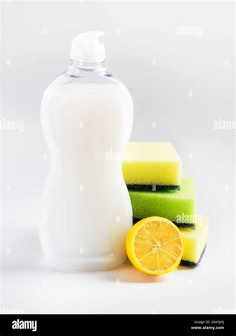 White Dishwashing Liquid In A Plastic Bottle Three Foam Sponges And