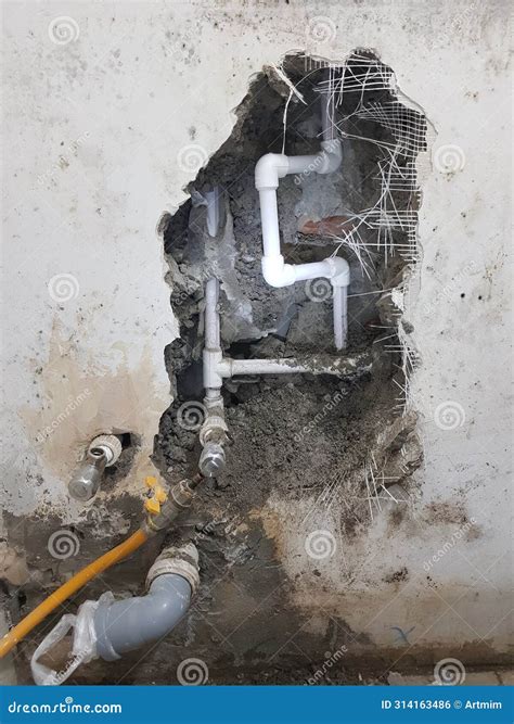 Damaged Wall Exposing Burst Water Pipes after Flood Stock Photo - Image
