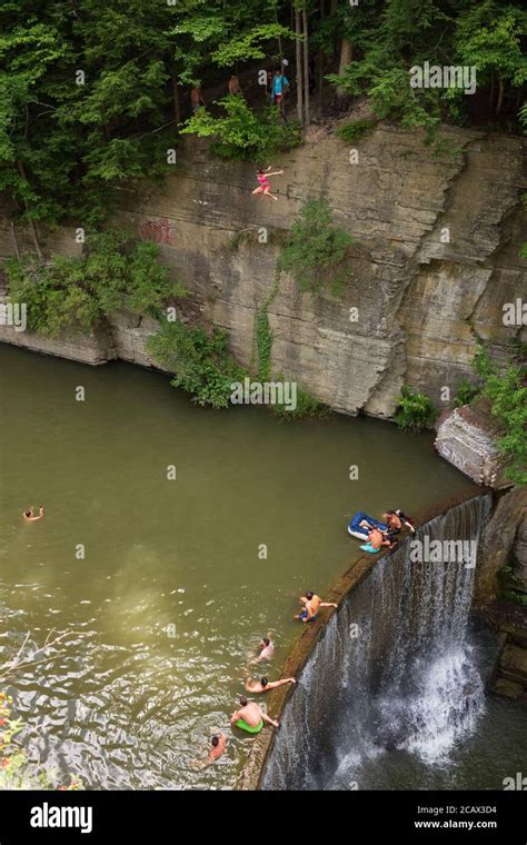 Ithaca Ny Usa Aug 2 2020 A Young Woman Jumps Off A Cliff Into A