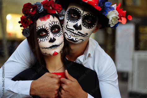 A couple, wearing skull make-up for. All souls day. Boy and girl sugar ...