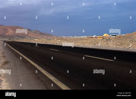 Straight road in desert Stock Photo - Alamy