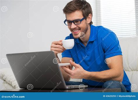 Handsome Young Man Working On Computer Laptop At Home Stock Image