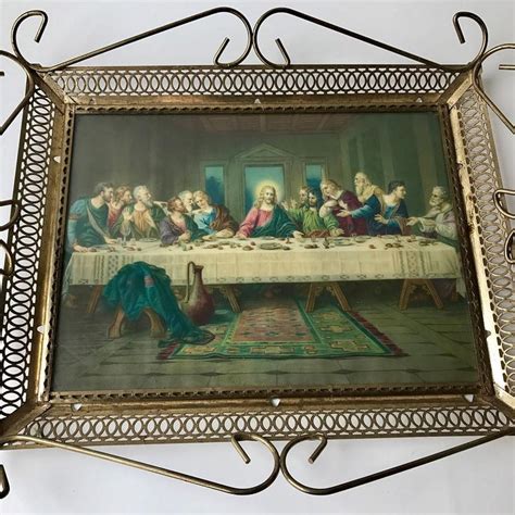 The Last Supper Of Jesus In An Ornate Metal Frame On A White Tablecloth