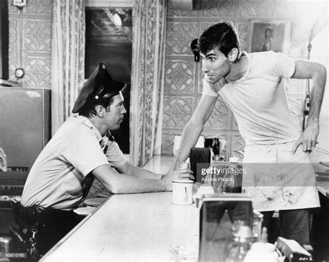 Warren Oates sits at a diner in a scene from the film 'In The Heat Of ...