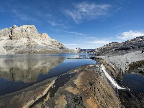 Waterfall And Reflection Of Mountains In Laguna De La Plaza El Cocuy