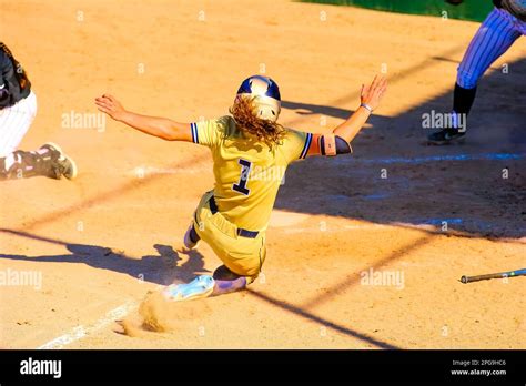 A Female Softball Player Is Sliding Into Home Plate Stock Photo Alamy