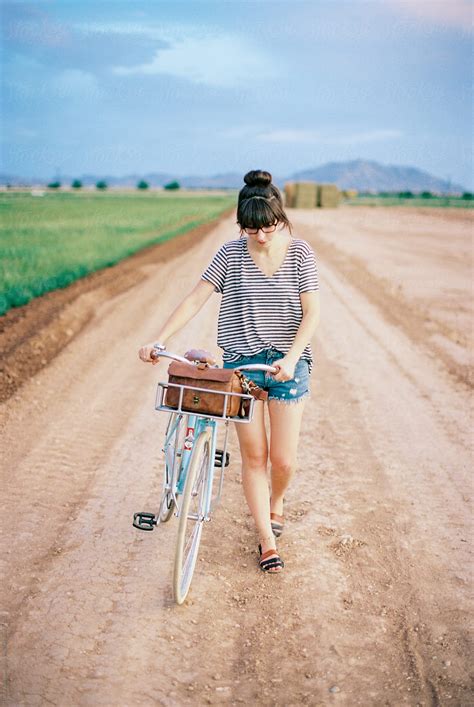 Girl Walking Bike On Dirt Road By Stocksy Contributor Daniel Kim