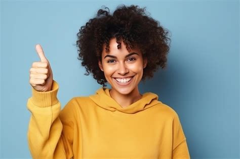 Premium Ai Image A Woman In A Yellow Sweater Gives A Thumbs Up