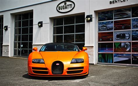 Orange Bugatti Veyron parked in front of a showroom wallpaper - Car wallpapers - #53822