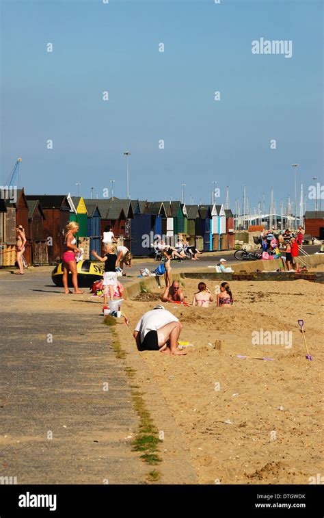 A View Of Beach Huts And Bathers At Hamworthy Poole Dorset Uk Stock