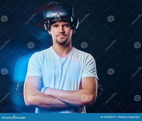 Pro Gamer With Bristle Dressed In White Shirt Wearing Virtual Reality Glasses And Holds