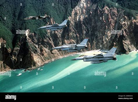 A Japanese Air Self Defense Force Mitsubishi F 1 Fighter Aircraft Top Flies With Three Usaf F