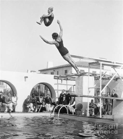 Swimmers Jumping Off The Diving Boards By Bettmann