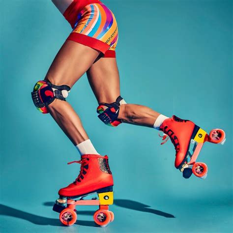 Legs Of A Slender Sporty Woman Wearing Multicolored Roller Skates And