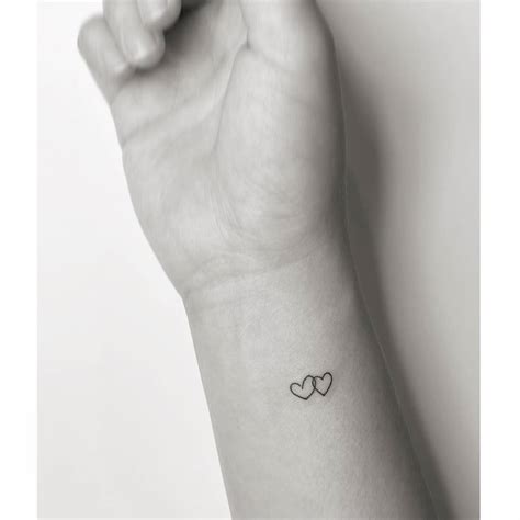 Minimalistic Pair Of Hearts Tattooed On The Wrist