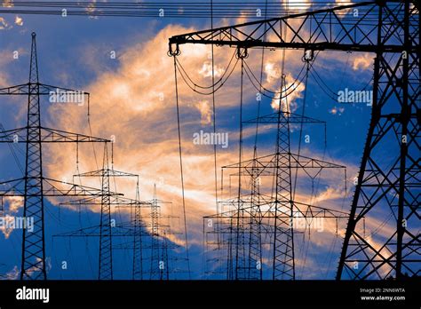 High Voltage Pylons For Electricity And Power Against Sky With Dramatic