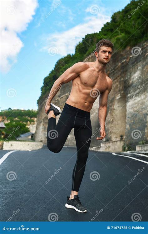 Fitness Man Stretching Body Exercising Before Running Outdoor Stock