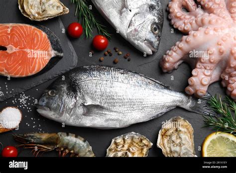 Fresh Dorado Fish And Other Seafood On Black Slate Background Flat Lay