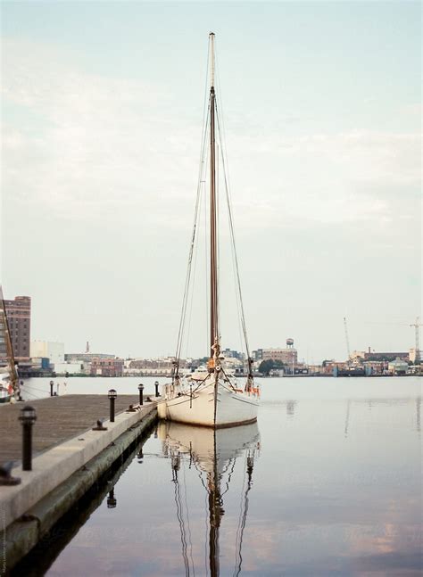 Sailboat Docked On Calm Morning Waters By Stocksy Contributor Marta