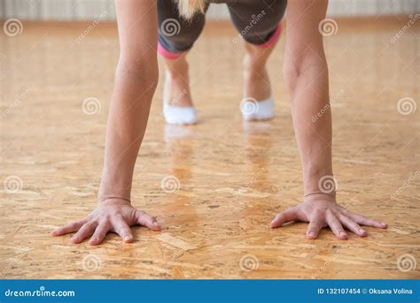 The Girl Practices Yoga In The Gym And Stands On The Arms In The Stock