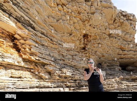 woman woman photographed on the rocks of Cape Kamenjak, a protected natural area on the southern ...