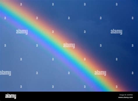 Rainbow and storm clouds Stock Photo - Alamy