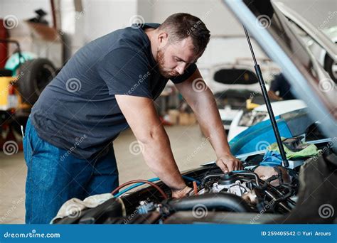 Giving Your Engine The Care It Needs A Mechanic Working On A Car In An